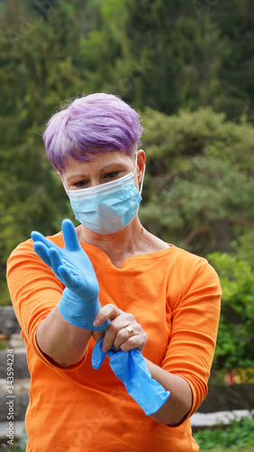 Woman with face mask, gloves. Woman in protective mask wearing rubber gloves. Woman wears a face mask that protects against the coronavirus. Close- up of a woman with a mask against SARS-cov-2.