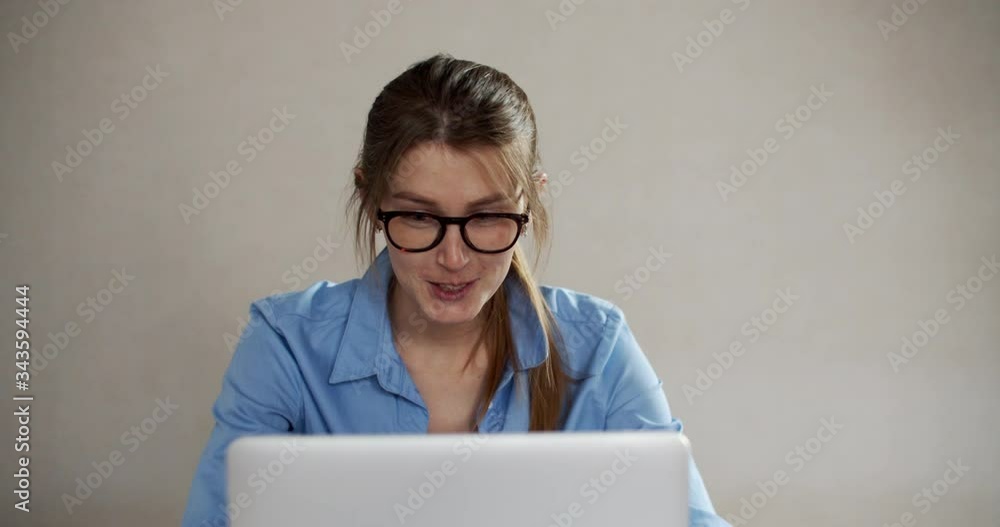 Young woman having video call via laptop in the office. Communication with family at a distance. Female portrait. Young woman having video call via laptop in the office. Communication with family at a distance. Female portrait.