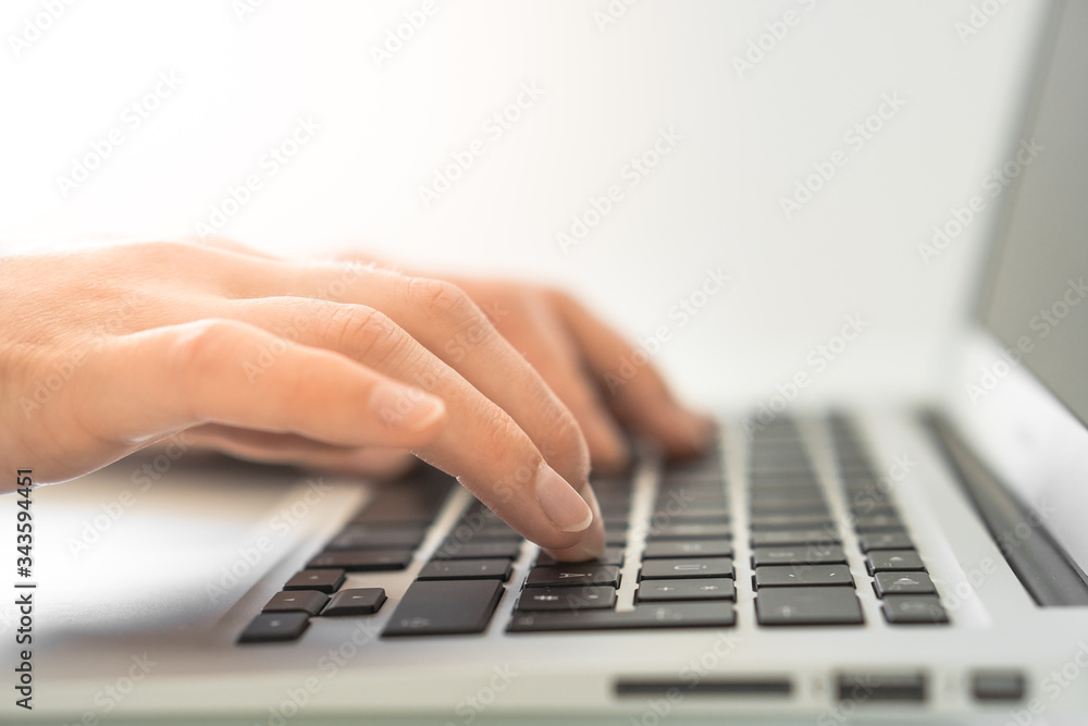 Hands writing on a Keyboard of a Laptop or Notebook in Home Office Hands writing on a Keyboard of a Laptop or Notebook in Home Office