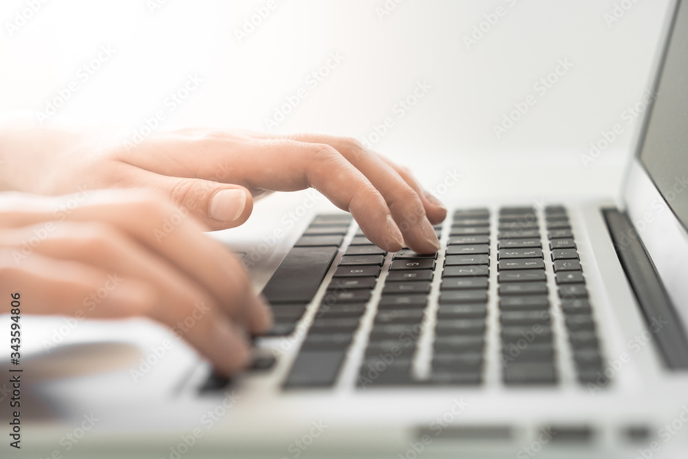 Hands writing on a Keyboard of a Laptop or Notebook in Home Office Hands writing on a Keyboard of a Laptop or Notebook in Home Office