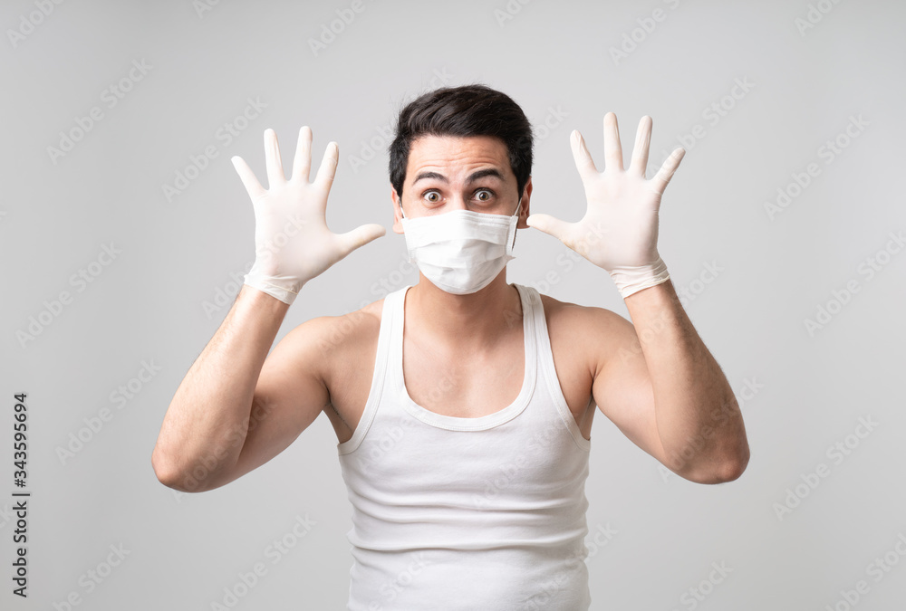 A well prepared man is having a wild smile with face mask and hands glove protect from coronavirus Covid-19 pandemic with copy space, self-quarantine, preparation, panic, prevention, lockdown. A well prepared man is having a wild smile with face mask and hands glove protect from coronavirus Covid-19 pandemic with copy space, self-quarantine, preparation, panic, prevention, lockdown.