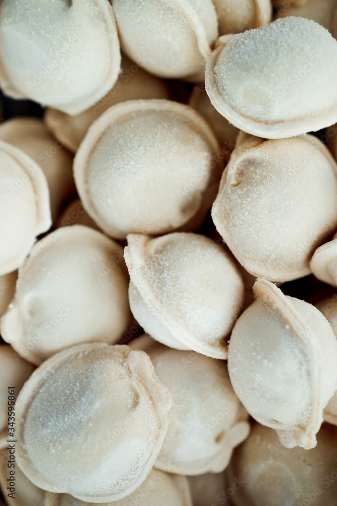 frozen dumplings. dumplings with meat, a lot of freshly frozen dumplings with grains of frost. culinary products made of dough with meat filling frozen dumplings. dumplings with meat, a lot of freshly frozen dumplings with grains of frost. culinary products made of dough with meat filling