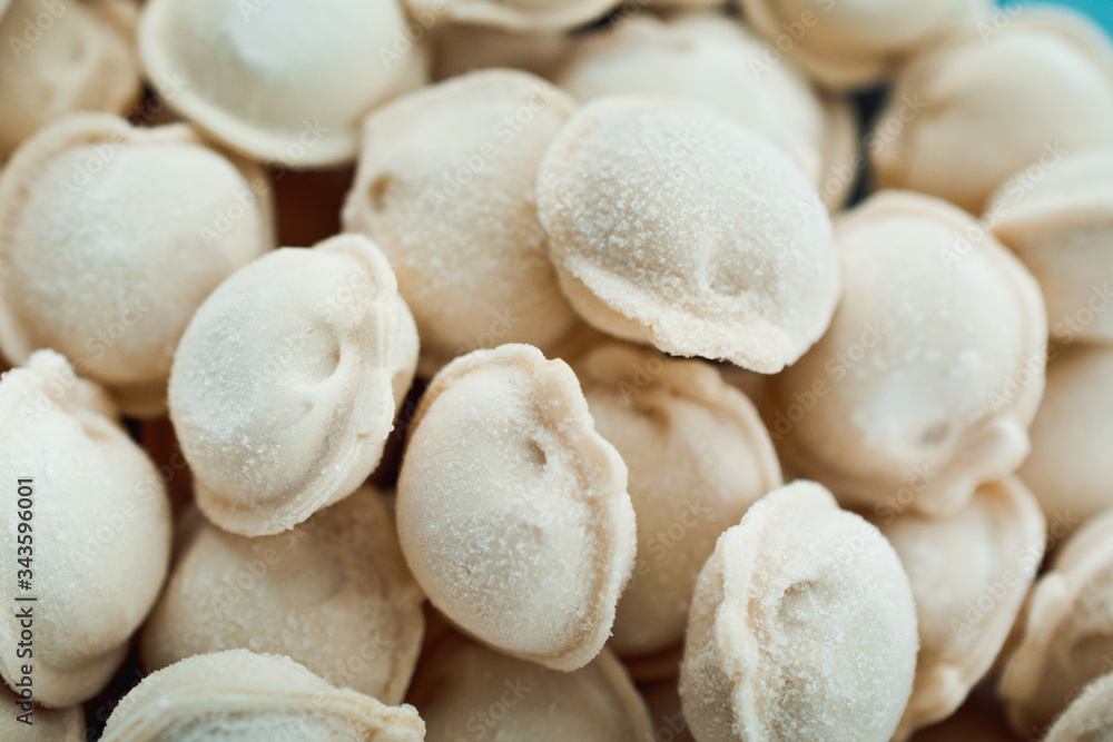 frozen dumplings. dumplings with meat, a lot of freshly frozen dumplings with grains of frost. culinary products made of dough with meat filling frozen dumplings. dumplings with meat, a lot of freshly frozen dumplings with grains of frost. culinary products made of dough with meat filling