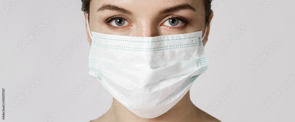 Young woman is wearing a face mask for protection against virus Young woman is wearing a face mask for protection against virus