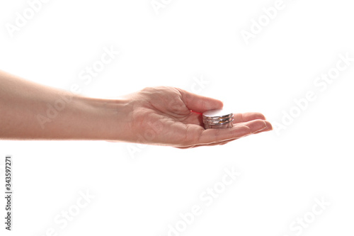 Female hand holds a small jar of cream