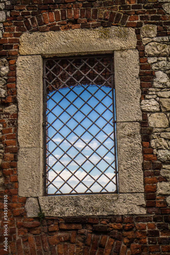 A Window in an ancient wallwith blue sky seen thorough it A Window in an ancient wallwith blue sky seen thorough it