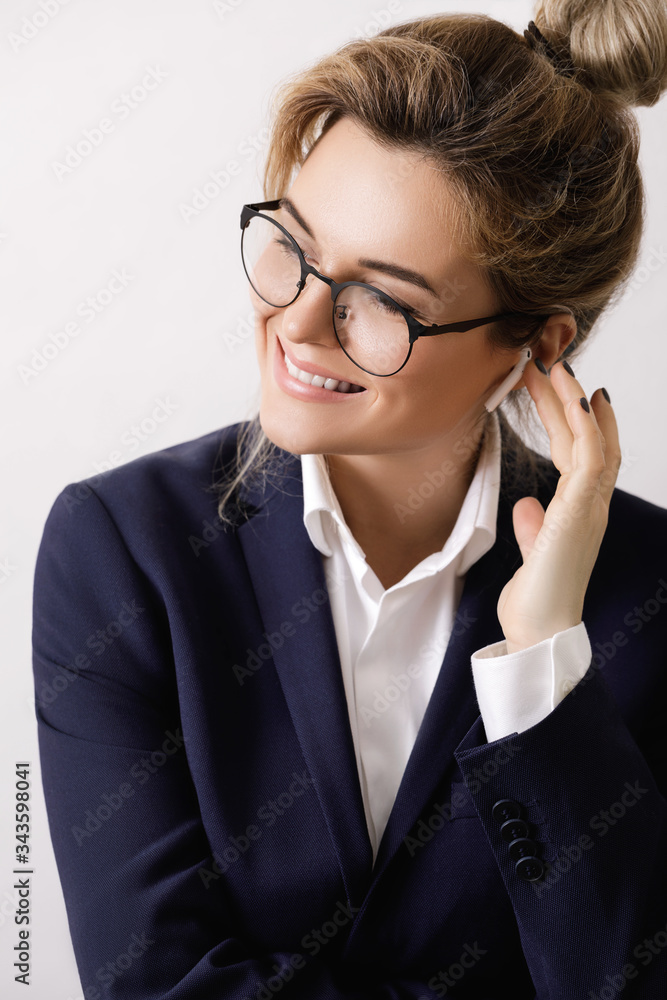 Bsinesswoman with wireless earbud in the ear Bsinesswoman with wireless earbud in the ear