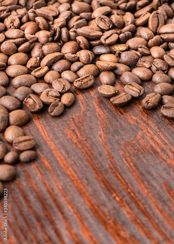 roasted coffee beans up-close on wood table