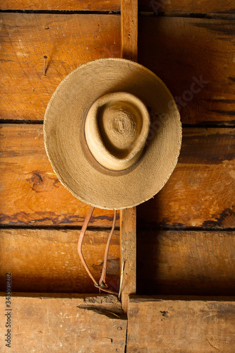 mexican style sombrero cowboy hat hanging on rustic barn wall 