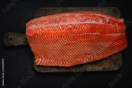 Trout fish fillet. Large, fresh and juicy piece of fish. .Fish on a wooden cutting board