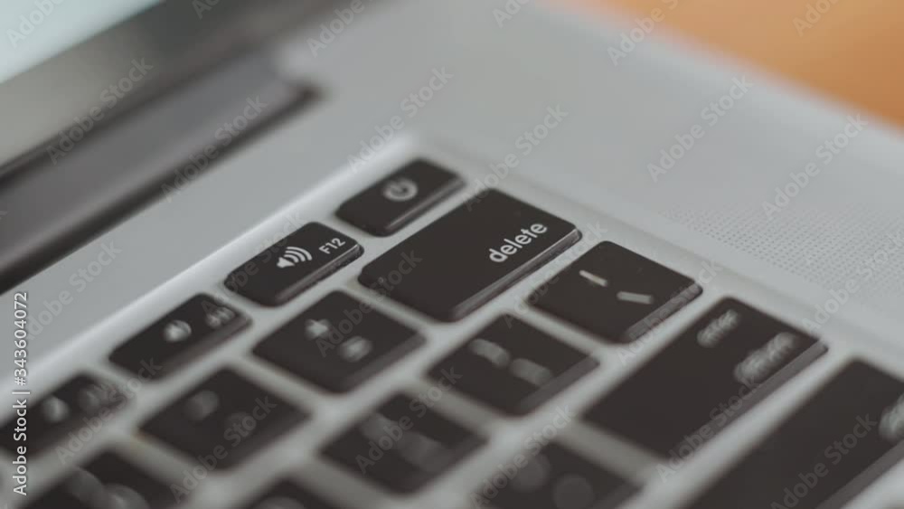 closeup of a keyboard and a finger, button delete. Hands closeup on the keybard. closeup of a keyboard and a finger, button delete. Hands closeup on the keybard.