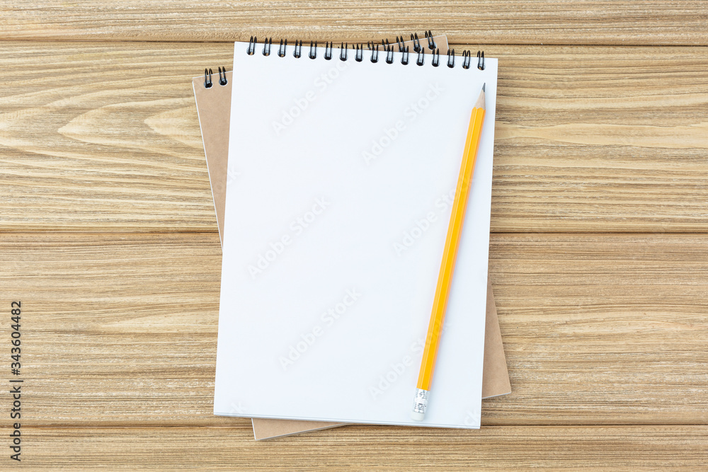 spiral notebook and pencil