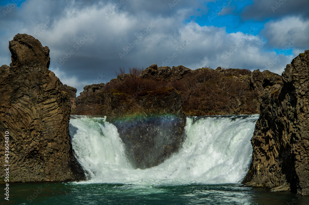 Rainbow bridge in Hjálparfoss waterfall, Iceland Rainbow bridge in Hjálparfoss waterfall, Iceland