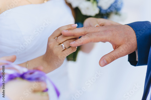 Golden rings at a wedding ceremony in the newlyweds on the fingers closeup. Photography  concept.