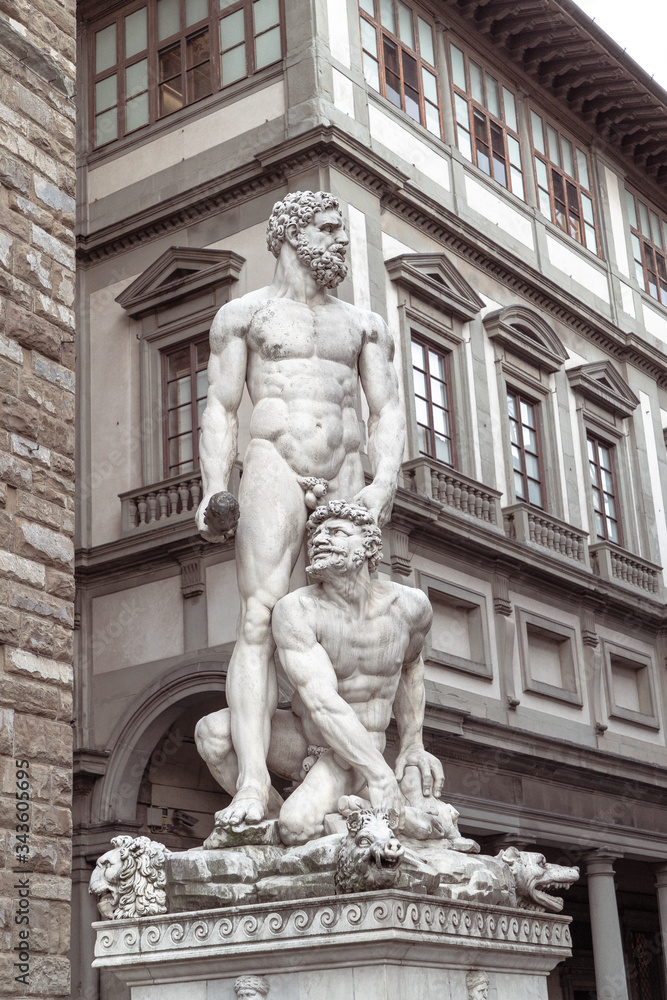A statue of two persons in front of a building