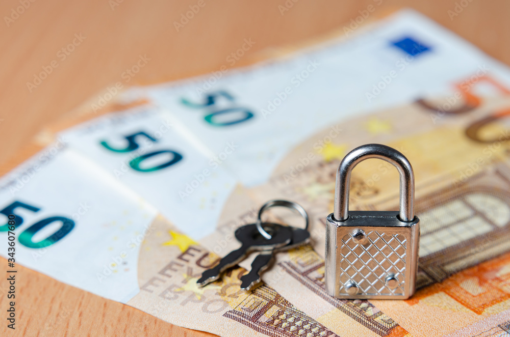 Lock and key on euro banknotes representing concept of financial control in the European Union. The economic future of Europe after the covid-19 crisis . Investments stopped due to the pandemic . Lock and key on euro banknotes representing concept of financial control in the European Union. The economic future of Europe after the covid-19 crisis . Investments stopped due to the pandemic .