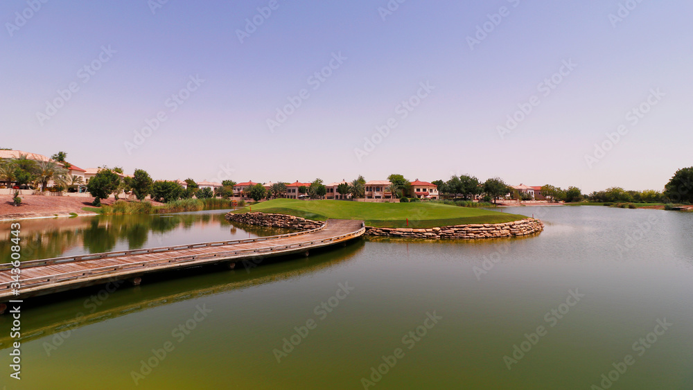Fototapeta premium beautiful golf course surround with lake in a sunny day.
