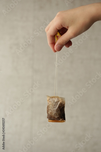 a tea bag in a man's hand
