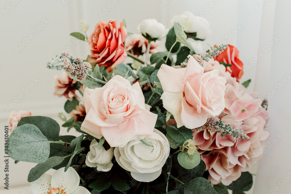 Obraz premium Bouquet with roses and green leaves on a white background