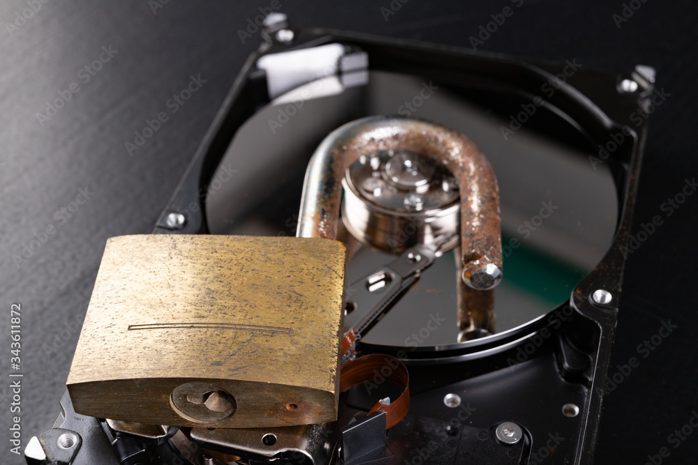 Digital storage disk and old padlock. Old digital data protection. Digital storage disk and old padlock. Old digital data protection.