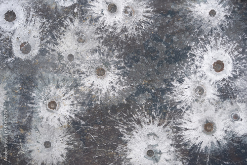 white splatters of lead spalling from a 45 pistol on a target