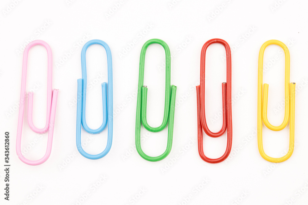 Multi colored paper clips on white. Multi colored paper clips on white.