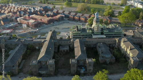 Aerial footage of military hospital clocktower being repaired during summer sunset in England photo