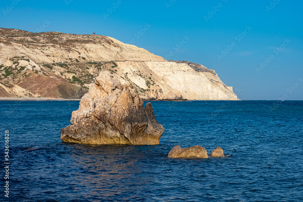 Aphrodite's Rock. Coast Of The Republic Of Cyprus. View from the sea on the Aphrodite rock and the rocky shore. Petra Tou Romiou. Pathos. Kuklia. Seascape. Holidays in Cyprus.