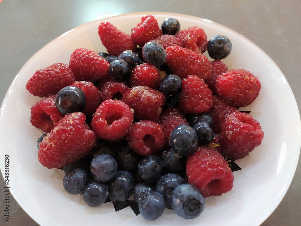 Raspberries and currants in a bowl. Dessert salad Raspberries and currants in a bowl. Dessert salad
