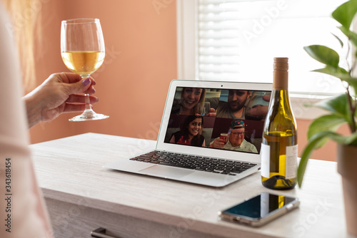 Bild auf Leinwand Woman enjoying a virtual happy hour with family during social distancing