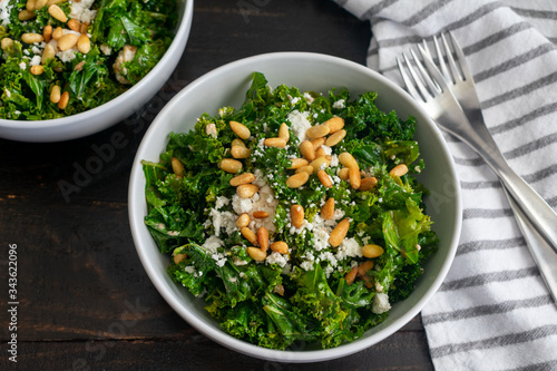 Kale Salad with Goat Cheese: Kale salad with sweet onion dressing topped with crumbled goat cheese and toasted pine nuts
