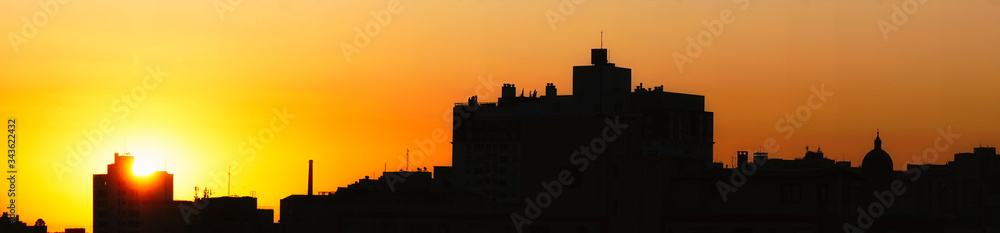 cityscape of Porto Alegre on the sunset with Gasômetro and Catedral Metropolitana, orange sky