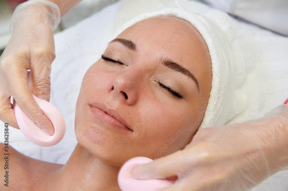 Happy female getting facial massage alternative medicine top view