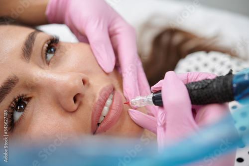 Permanent lip tattoo liner coloring around the vermilion border of the lips