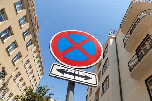 No stopping traffic sign on a narrow street between apartment buildings in Prague photo