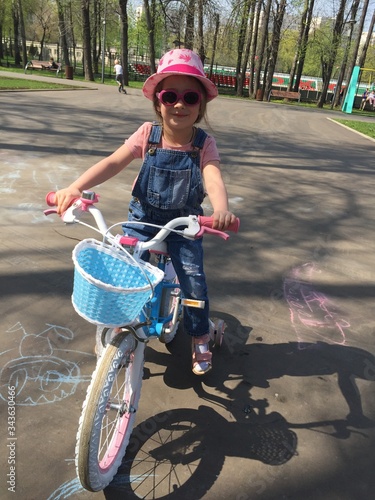 A girl rides a Bicycle. photo