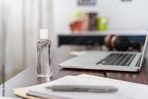 Hand sanitizer bottle, mockup dispenser alcohol gel, on desk home office, laptop paperwork antibacterial coronavirus quarantine isolation, small squeezable dispenser