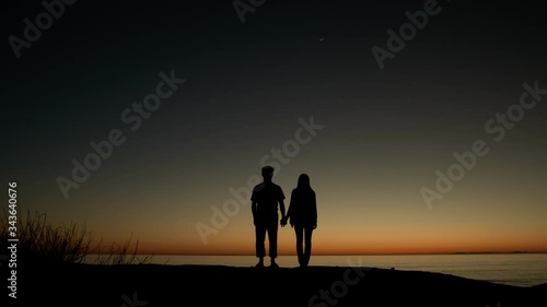 silhouette of a couple at sunset photo