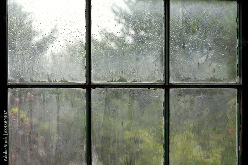 Rainy day viewed through an old window. 