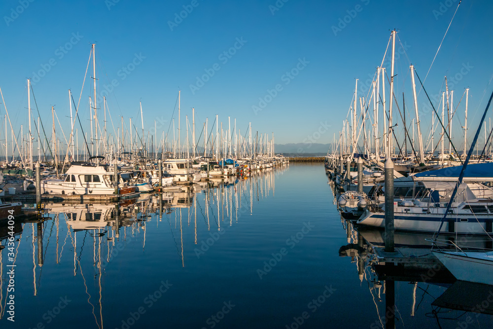 Fototapeta premium Receding boats and mast reflections in marina