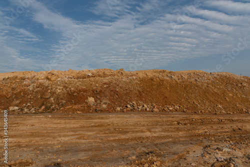Large dirt pile against the sky background