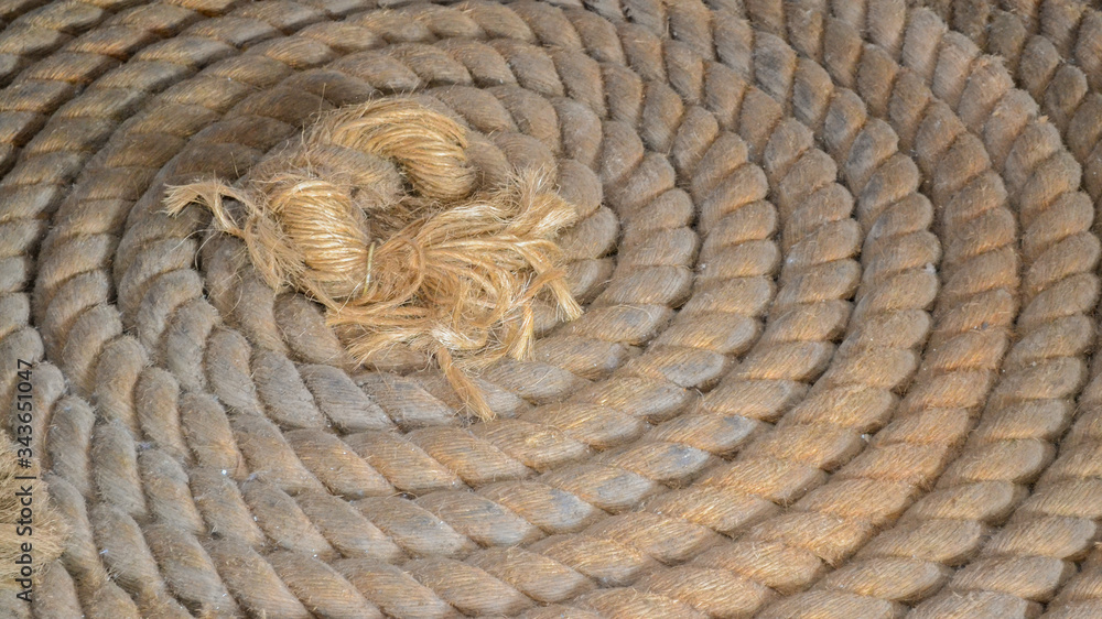 Coils of thick rope in a spiral pattern. Large rope texture on a sailing  ship background. Coiled up rope boat equipment Stock Photo