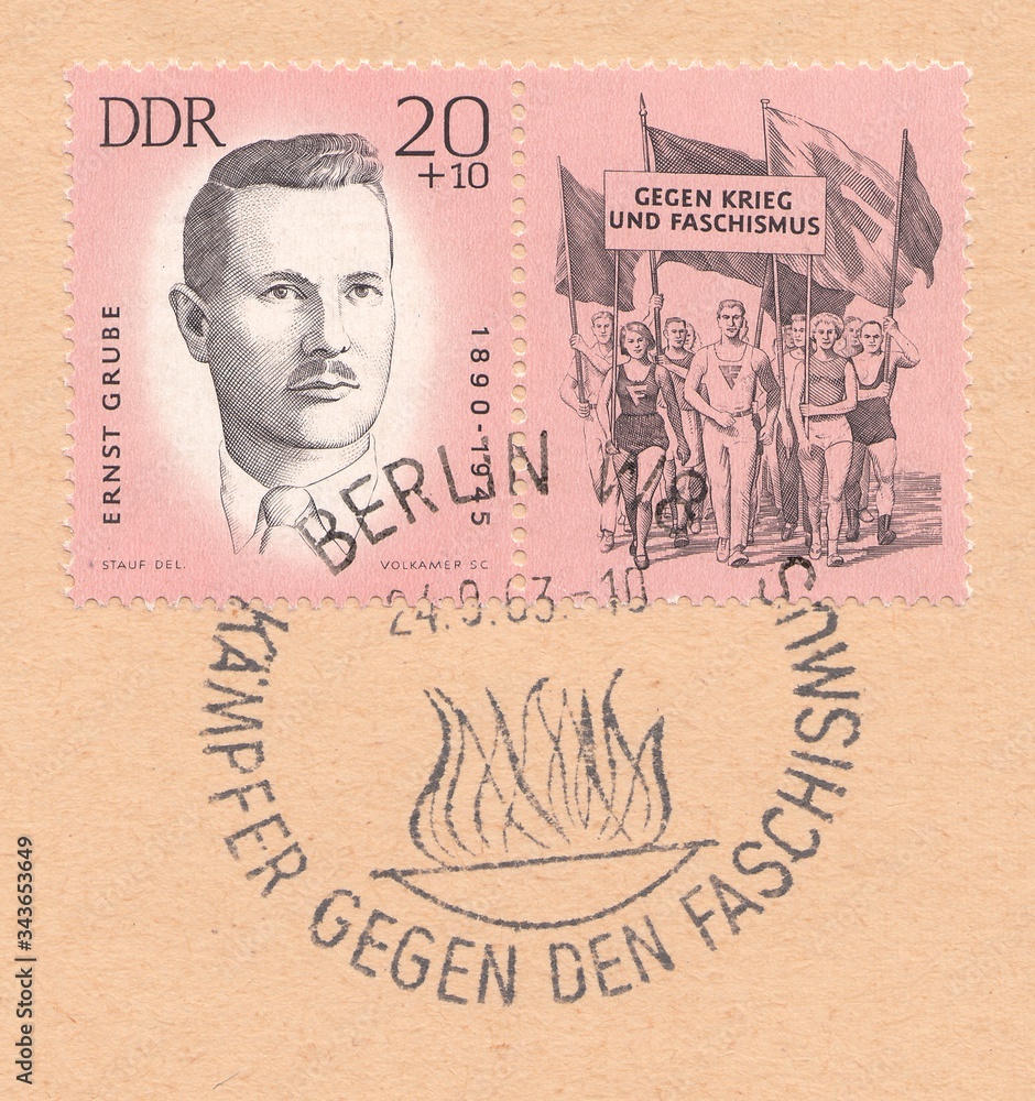 Fototapeta premium Portrait of Ernst Grube-German Communist. March of athletes with flags and a banner 