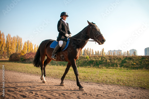 Beautiful Smiling Girl Jockey Stand Next To Her Brown Horse Wearing Special © tsirika