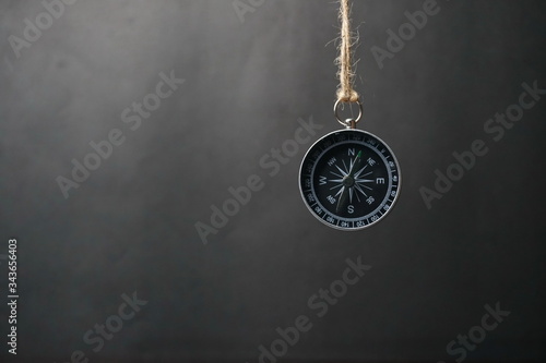 Close up of Magnetic compass, travel compass on dark background, business and creative concept