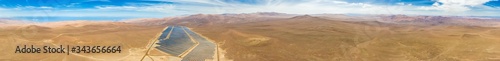 Aerial drone view of a Solar Energy Photovoltaic Power Plant over Atacama desert sands, Chile. Sustainability and green energy from the sun with Solar Energy in the driest desert in the world: Atacama