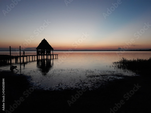 Fotografiet Un hermosa atardecer el las orillas de la majestuosa laguna Isireri, llena de le