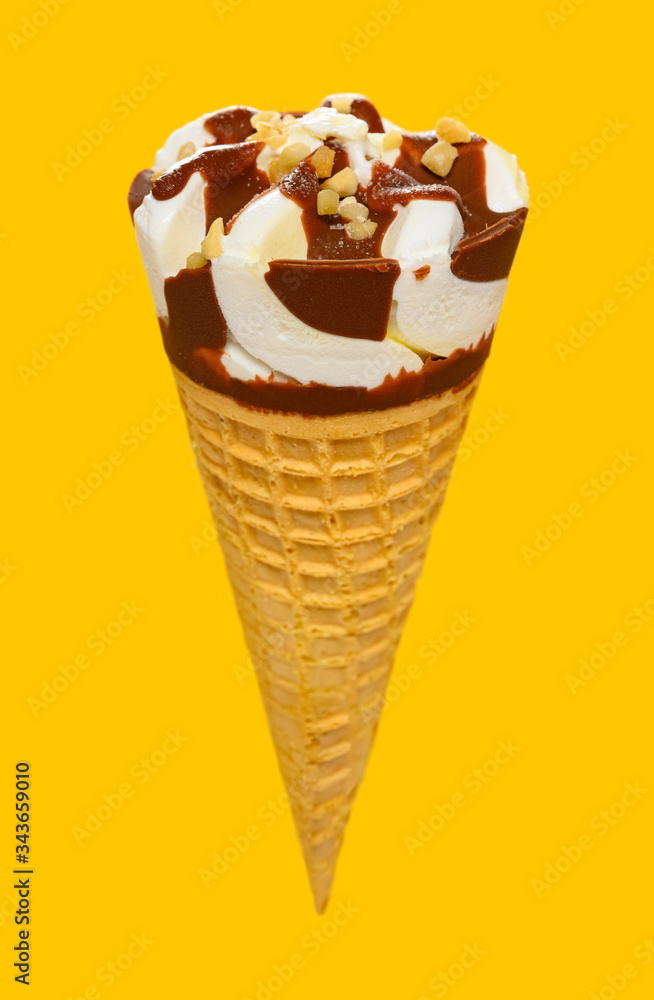 angle view fresh vanilla flaovr ice cream cone with chocolate on a yellow background angle view fresh vanilla flaovr ice cream cone with chocolate on a yellow background