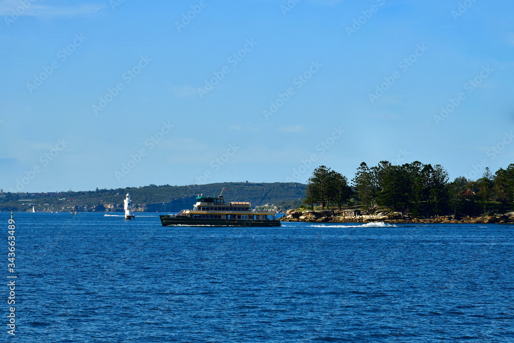 A ferry cruises across Sydney Harbor after pulling out from Rose Bay Wharf