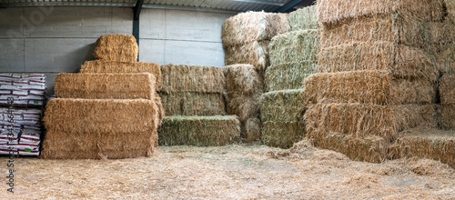 Fotografia Haystacks sorted inside an agricultural modern warehouse in Extremadura at the Spanish countryside